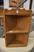 A small pine corner shelf unit.