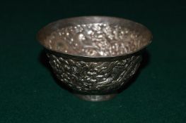 An Eastern embossed white metal bowl.