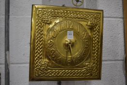 An Arts and Crafts wall clock with embossed brass dial.
