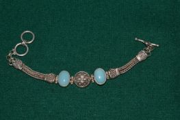 A silver and hard stone bracelet.