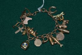 A 9ct gold bracelet mounted with 9ct gold and other charms.