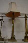 A brass table lamp.