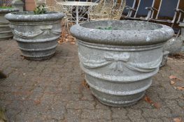 A very good large pair of weathered reconstituted stone circular garden urns of classical style.
