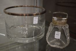 A cut glass jar with engraved white metal collar together with a large circular glass bowl with