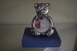 A Carrs silver teddy bear shaped photograph frame with original box.
