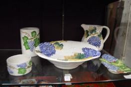 A small group of grape and vine decorated pottery.