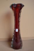 A large red and clear glass vase.