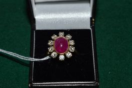 An 18ct gold, diamond and cabochon ruby flower head cluster ring.