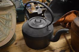 A large cast iron kettle.