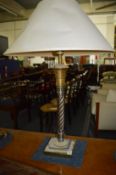 A chrome and brass table lamp.