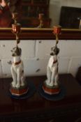 A pair of amusing porcelain dog candlesticks.