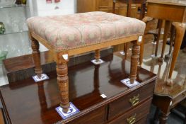 An upholstered stool.