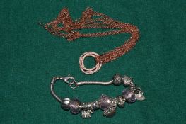 A silver bracelet, pendant and chain.