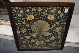A Chinese embroidered panel depicting a peacock, framed and glazed.