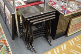 A chinoiserie decorated lacquer nest of four tables.