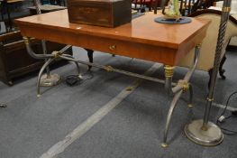 A French Empire style mahogany two drawer desk on chrome and brass X shaped supports.