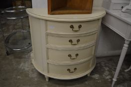 A Laura Ashley cream painted bow front four drawer chest.