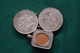 Two coin boxes and a coin holder.