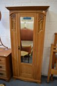 A Victorian satin walnut single door wardrobe.