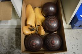 Four bowling woods and a pair of shoe trees.