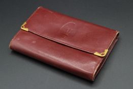 A CARTIER LEATHER PURSE.