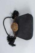 A BLACK LINEN BAG with large metal clasp. Signed AUSEIZE. 8ins.
