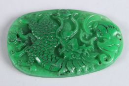 A CHINESE CARVED JADE DRAGON PENDANT. 3.5ins x 2ins.
