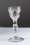 AN 18TH CENTURY WINE GLASS with engraved bowl and facet stem. 14cms high.