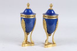 A GOOD PAIR OF 18TH CENTURY BLUE PORCELAIN URNS AND COVERS with gilt metal pineapple finial, on claw