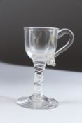 AN 18TH CENTURY WINE GLASS with handle and white twist stem. 12cms high.