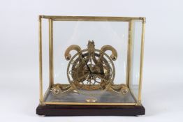 A GLASS CASED BRASS SKELETON CLOCK. 10ins high.