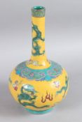 A CHINESE PORCELAIN YELLOW STRAIGHT NECK VASE decorated with dragons. 23cm high