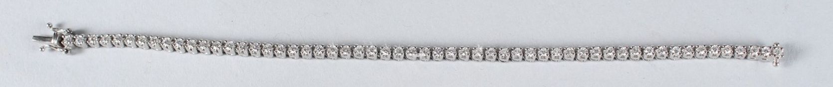 AN 18CT WHITE GOLD DIAMOND SET LINE BRACELET.