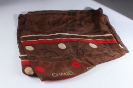 A CHANEL BROWN SILK SCARF in a Chanel box.