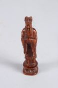 A CARVED WOOD GOD FIGURE. 4ins high.