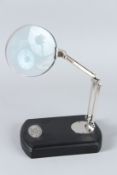 A MAGNIFYING GLASS on a stand.