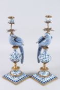A GOOD PAIR OF BLUE AND WHITE PORCELAIN PARROT CANDLESTICKS on square bases.