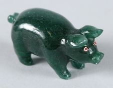 A RUSSIAN JADE PIG with gold and diamond eyes. 4.5cms high, in a Faberge box.