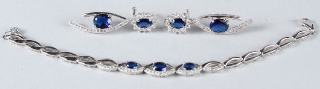 A SILVER AND CZ BRACELET AND PAIR OF EARRINGS.