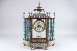 A CLOISONNE MANTLE CLOCK, the central four glass sections flanked by columns, the top with urn