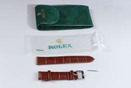 A ROLEX LEATHER WATCH STRAP in a suede pouch.