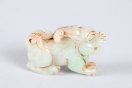 A CHINESE CARVED JADE FOO DOG. 1.75ins high.