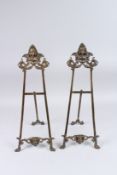A SMALL PAIR OF BRONZE EASELS. 22ins high.