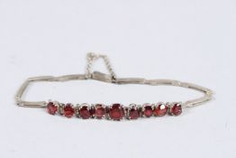 A SILVER AND GARNET BRACELET.