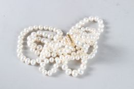 A VERY GOOD TRIPLE ROW OF PEARLS with gold clasp.