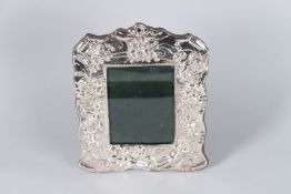 A SILVER CUPID PHOTOGRAPH FRAME. 23cms x 18cms.