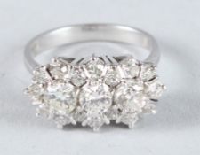 AN 18CT WHITE GOLD TRIPLE DIAMOND CLUSTER RING.