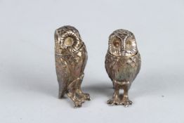 A SMALL PAIR OF CAST SILVER OWL SALT AND PEPPERS. 5cms high. Birmingham 1863.