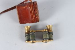 A SUPERB SMALL PAIR OF FOLDING BRASS AND ENAMEL BINOCULARS decorated with garlands, in a folding