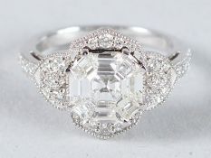 AN 18CT WHITE GOLD DECO STYLE ASSCHER CUT DIAMOND CLUSTER RING.